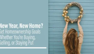 A woman with her back turned holds a rustic twig wreath adorned with gold ornaments against a teal wooden wall, next to text reading New Year, New Home? Set Homeownership Goals.A seasonal marketing banner promoting real estate and homeownership planning goals for individuals looking to buy, sell, or stay put in the new year.